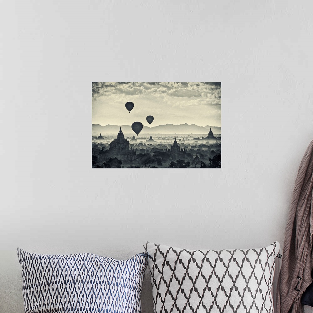 A bohemian room featuring This monochromatic photograph shows a landscape of hot air balloons rising above the stupas of an...