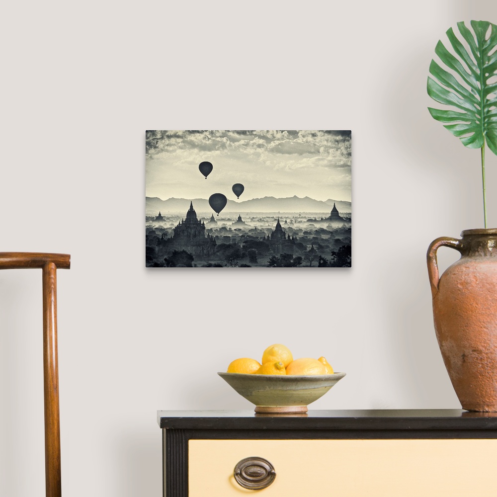 A traditional room featuring This monochromatic photograph shows a landscape of hot air balloons rising above the stupas of an...