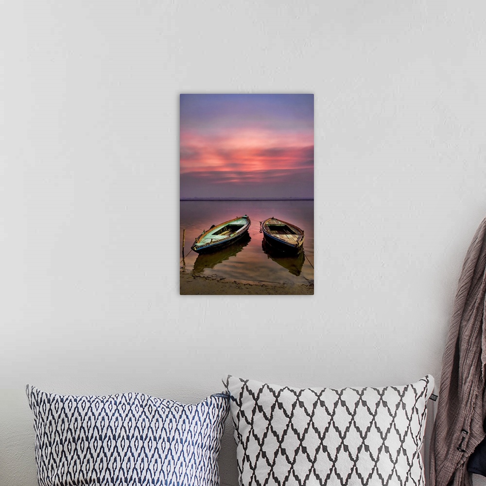A bohemian room featuring Picture of two empty wooden boats tied to the sandy shore in the early morning sunrise.