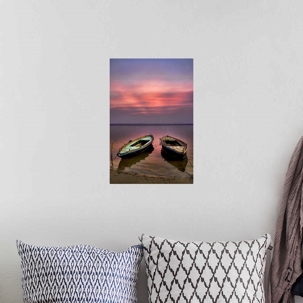 A bohemian room featuring Picture of two empty wooden boats tied to the sandy shore in the early morning sunrise.