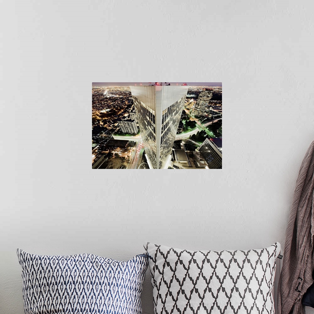 A bohemian room featuring Aerial photo of a triangular building in Los Angeles with the rest of LA lit up in the darkness b...