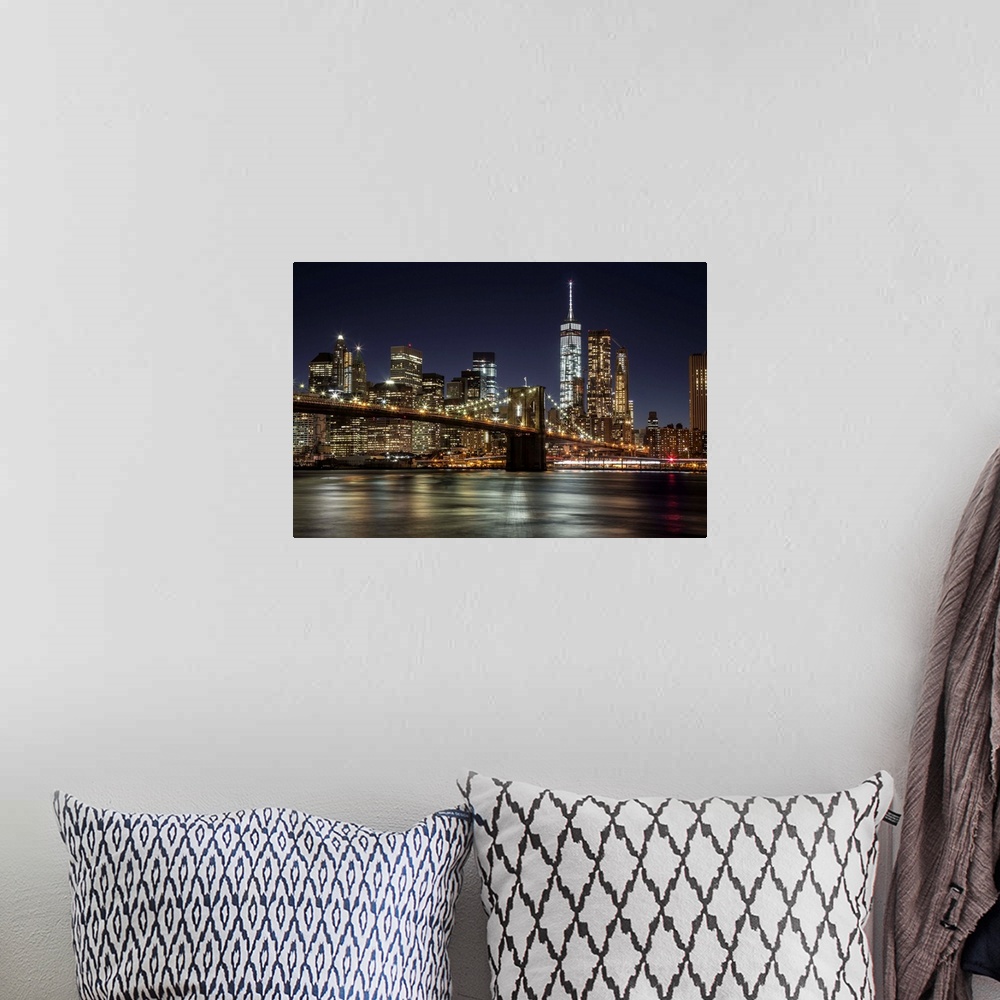 A bohemian room featuring The Brooklyn Bridge and view of NYC after dark.