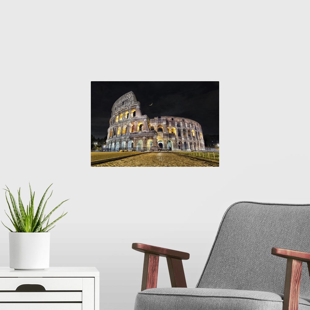 A modern room featuring The Coliseum after dark in Rome, Italy