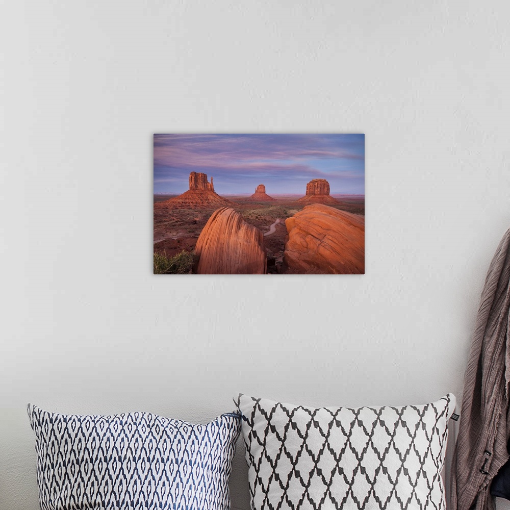 A bohemian room featuring The Mittens in Monument valley, Arizona at sunset