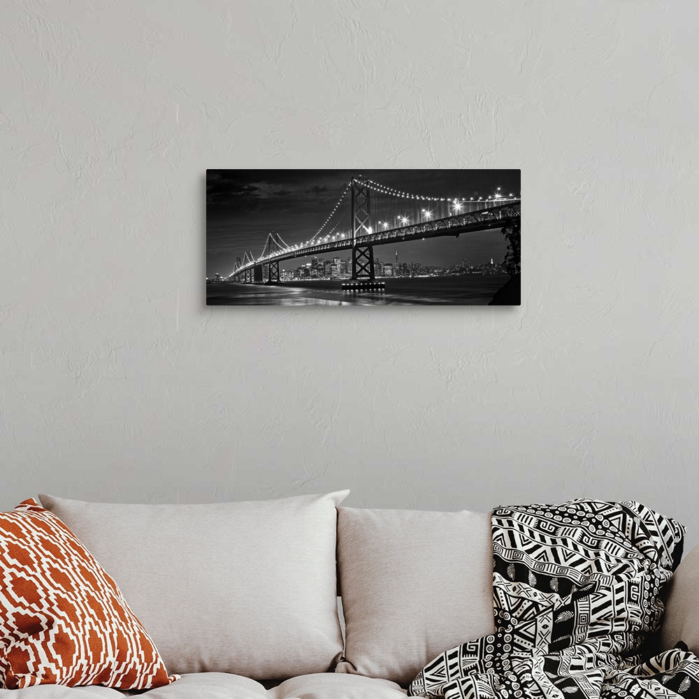 A bohemian room featuring The Oakland Bay Bridge after dark