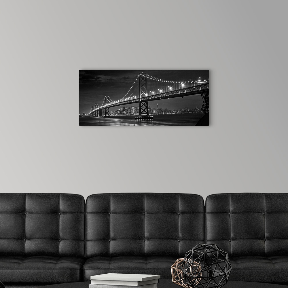 A modern room featuring The Oakland Bay Bridge after dark