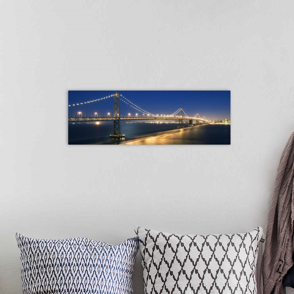A bohemian room featuring The Oakland Bay Bridge after dark in San Francisco
