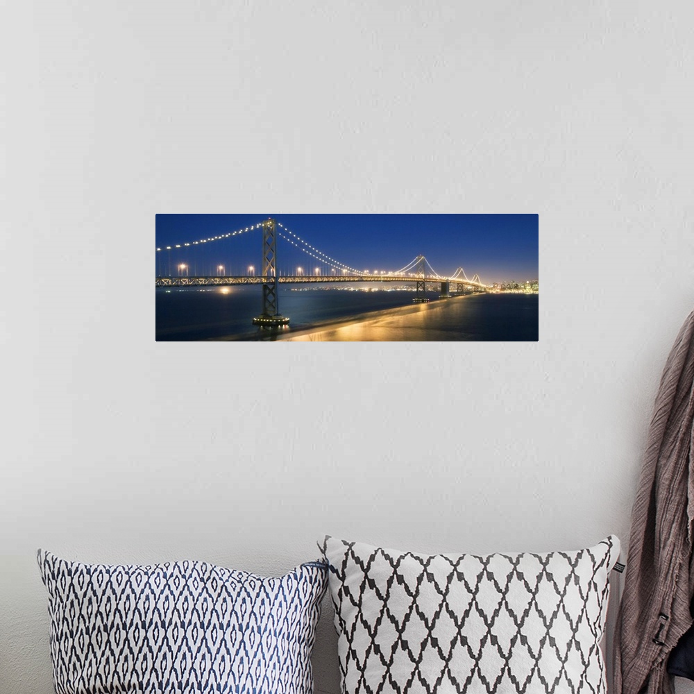 A bohemian room featuring The Oakland Bay Bridge after dark in San Francisco