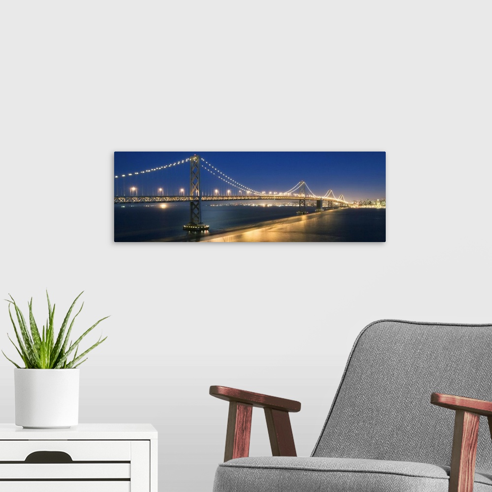 A modern room featuring The Oakland Bay Bridge after dark in San Francisco