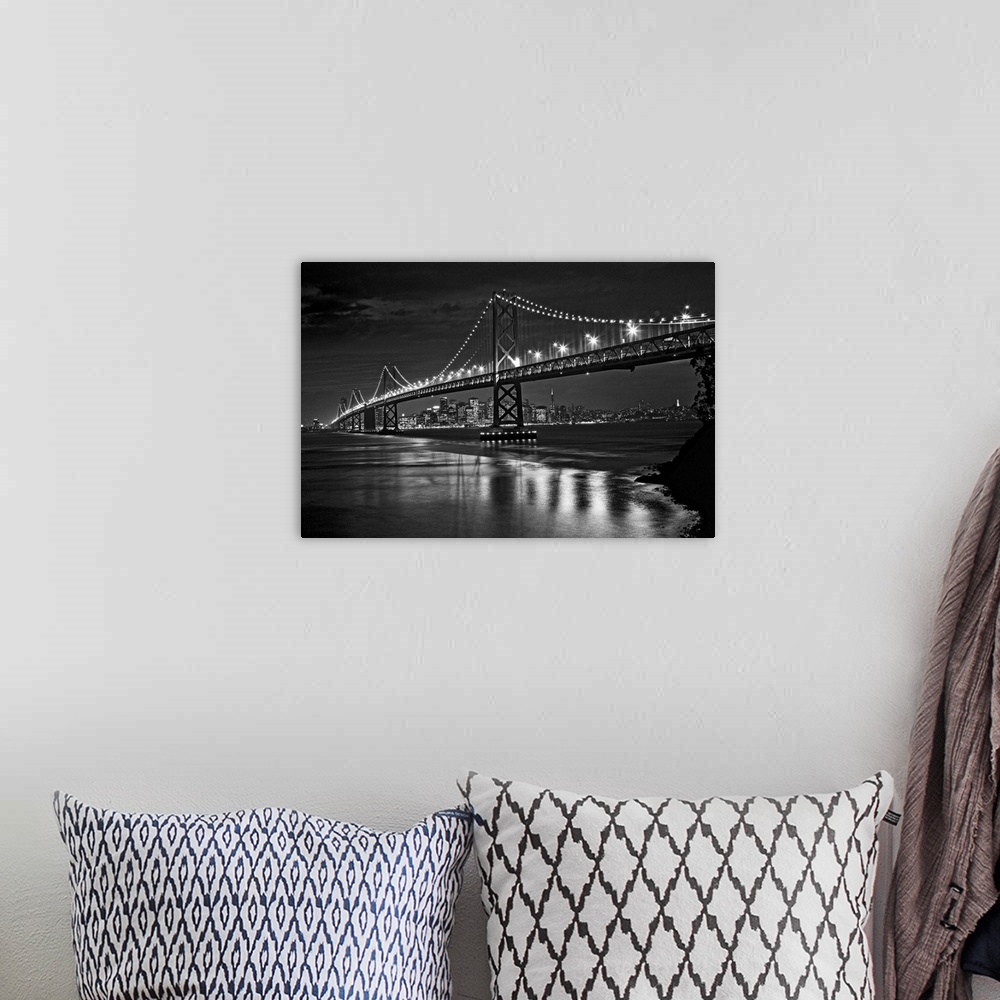 A bohemian room featuring This landscape is a high contrast, monochromatic photograph that shows a bridge in the fore groun...