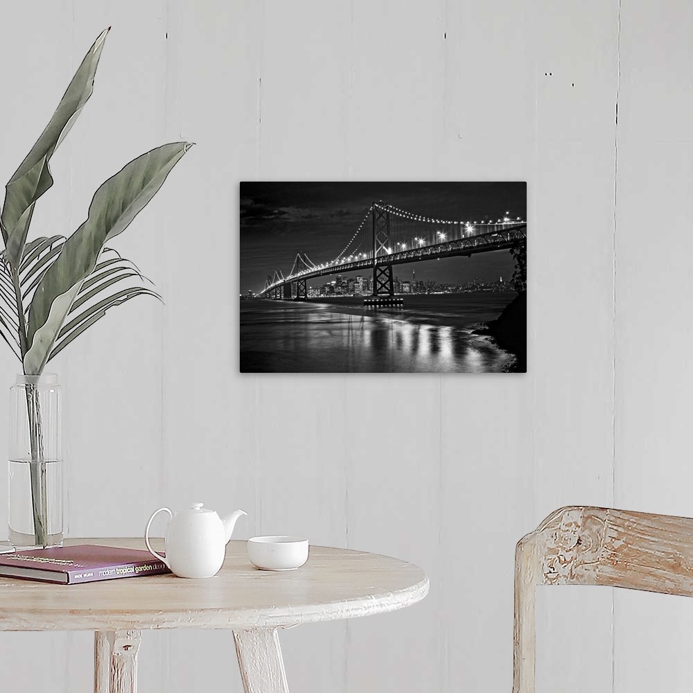 A farmhouse room featuring This landscape is a high contrast, monochromatic photograph that shows a bridge in the fore groun...