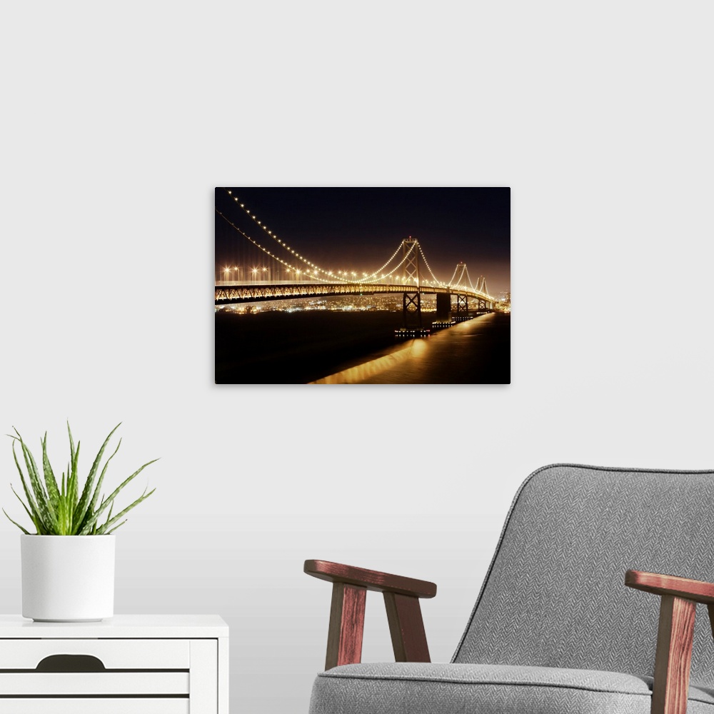 A modern room featuring The Oakland Bay Bridge at night, San Francisco