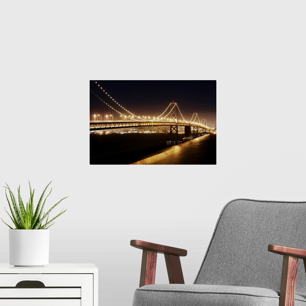 A modern room featuring The Oakland Bay Bridge at night, San Francisco