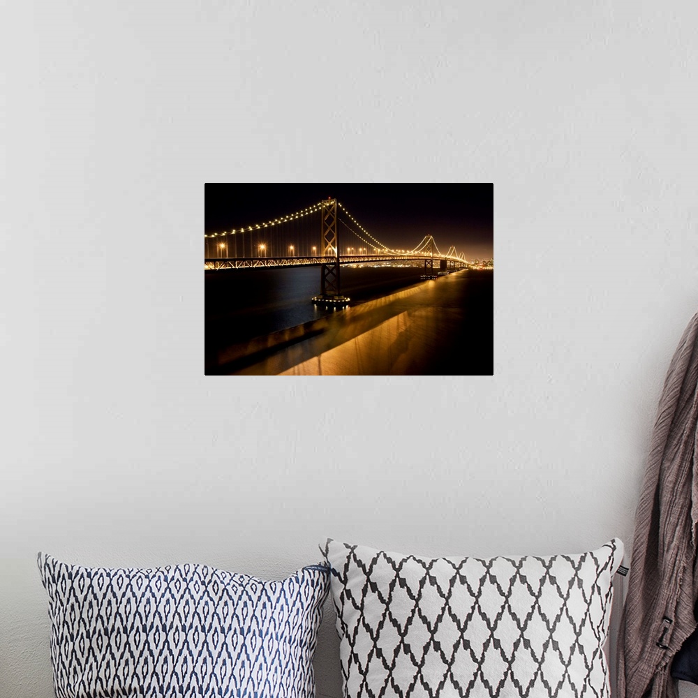 A bohemian room featuring The Oakland Bay Bridge at night, San Francisco