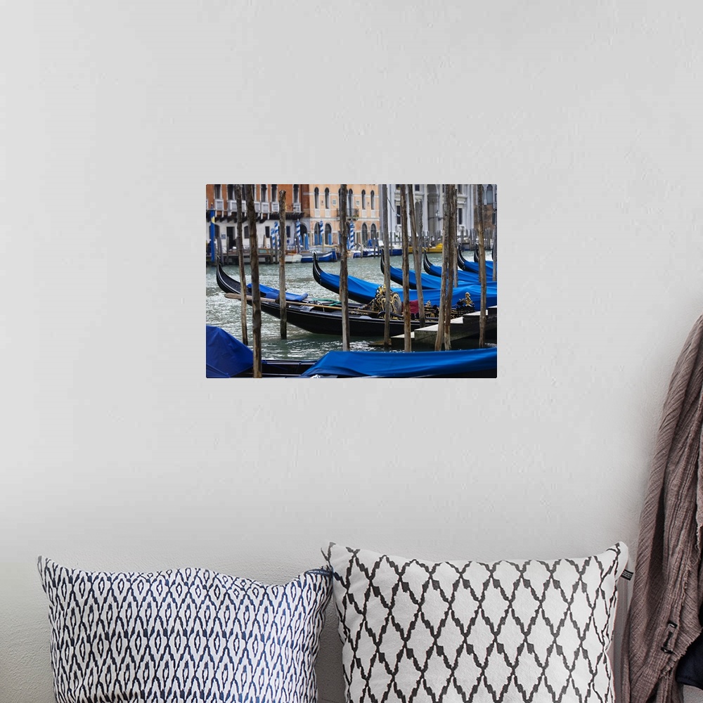 A bohemian room featuring Photograph taken of a river in Venice that is lined with gondola boats that are tied up and have ...