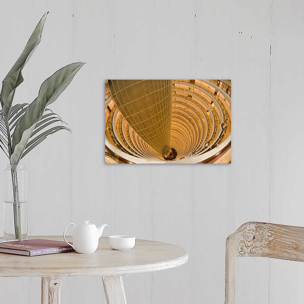 A farmhouse room featuring This large piece is a photograph that has been taken inside an extremely tall hotel and looking d...