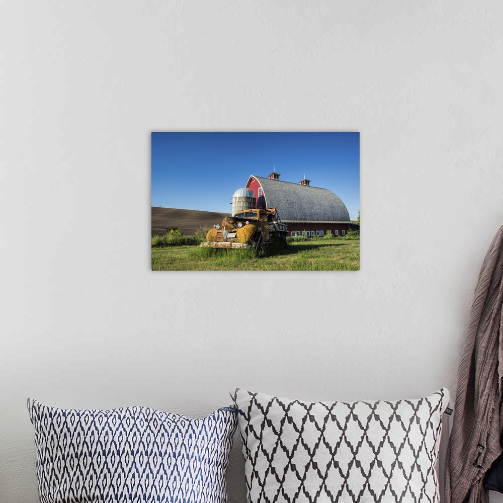 A bohemian room featuring Vintage pickup truck and red barn in the Palouse region of Washington State