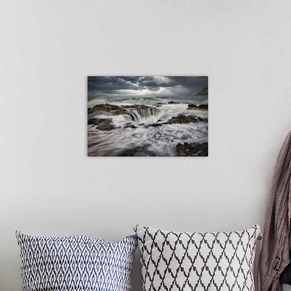 A bohemian room featuring Waves crashing into Thors Well on the Oregon Coast.