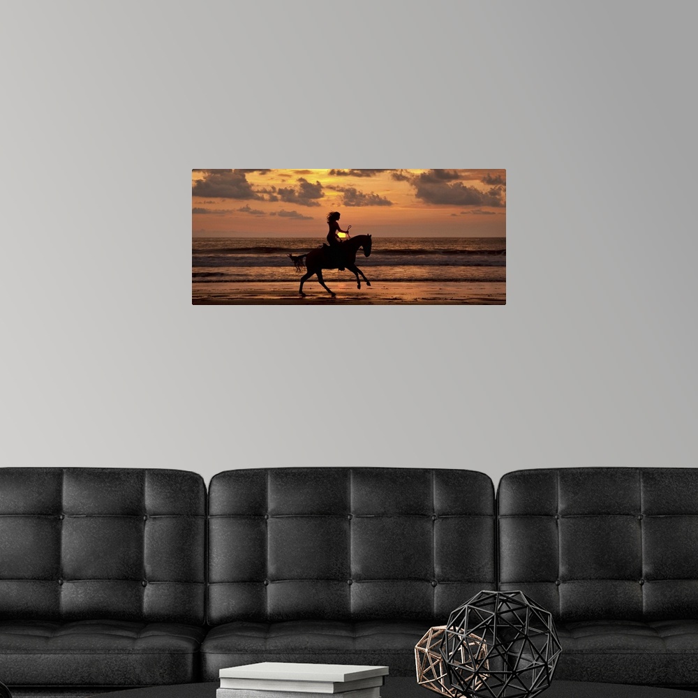 A modern room featuring Woman riding a horse on the beach at sunset in Costa Rica