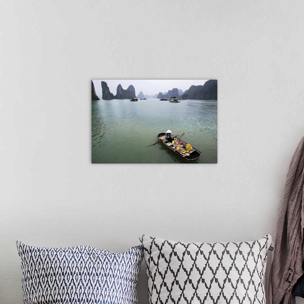 A bohemian room featuring Woman selling fruit by her floating village, Halong Bay, Vietnam