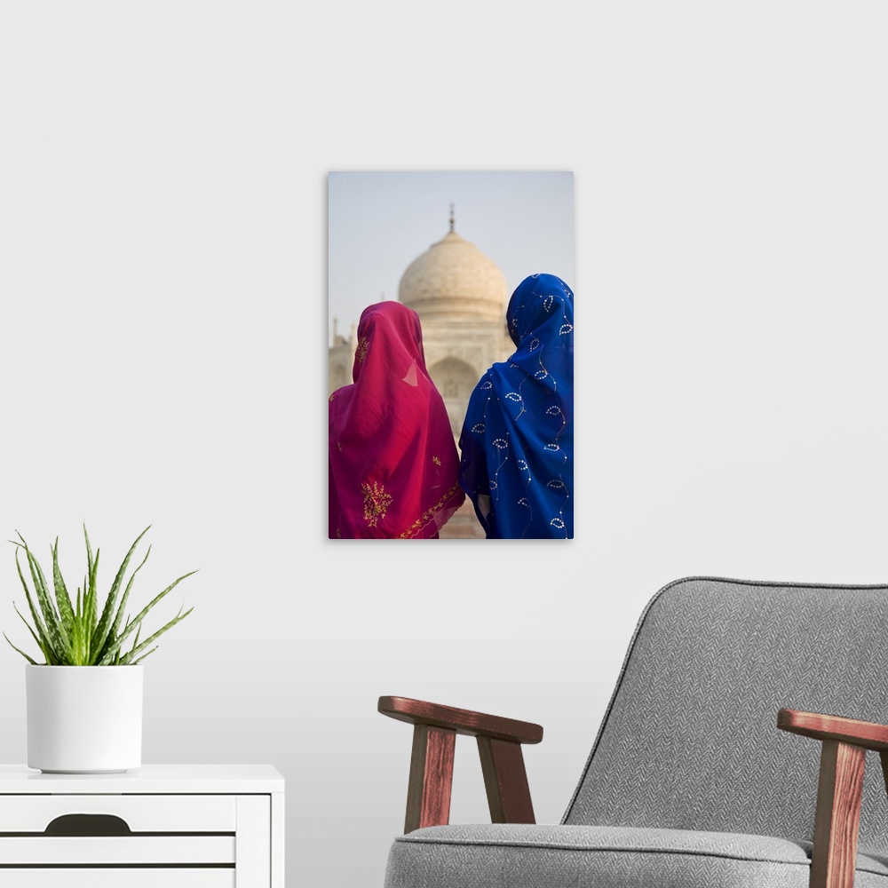 A modern room featuring Women praying by the Taj Mahal, Agra, India