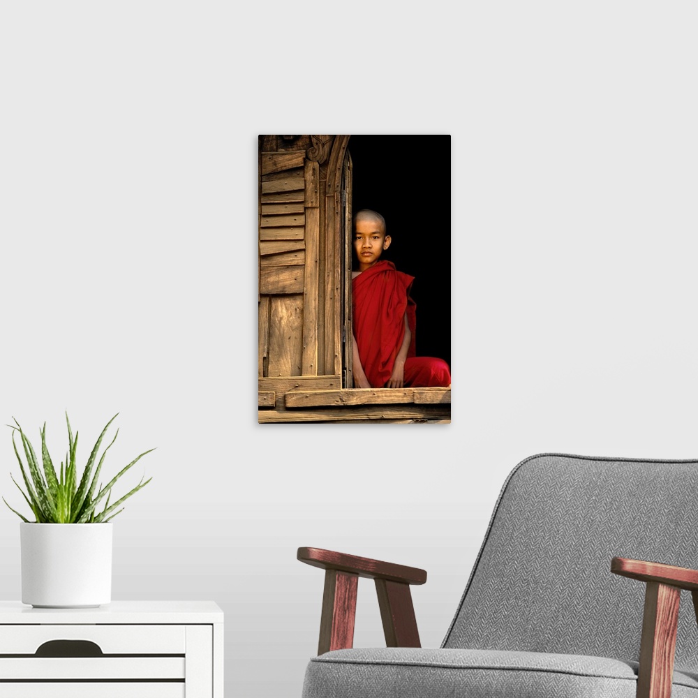 A modern room featuring Young Burmese monk in his monastery, Bagan, Burma