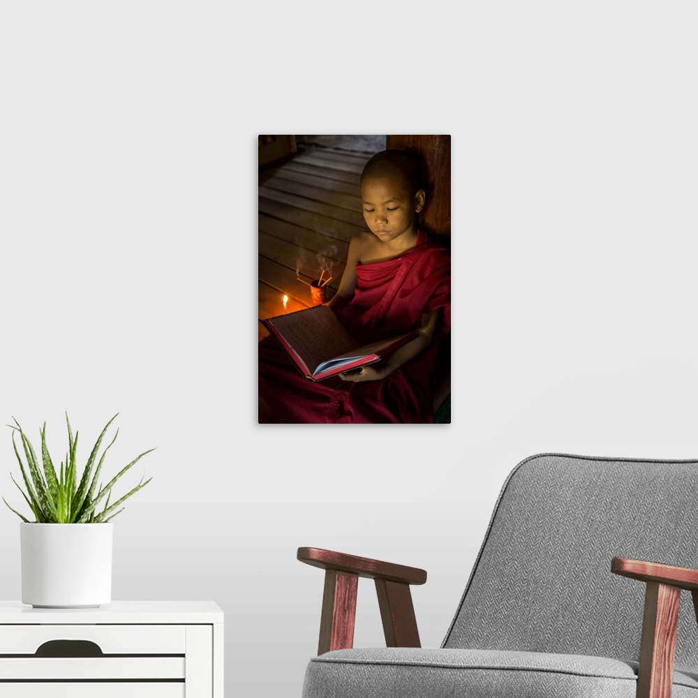 A modern room featuring Young Burmese monk in his monastery in Bagan.