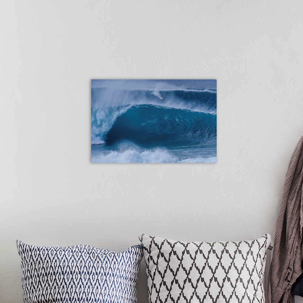 A bohemian room featuring A surfer rides a wave from the outer reef at the legendary pipeline surf spot on Oahu's north shore.