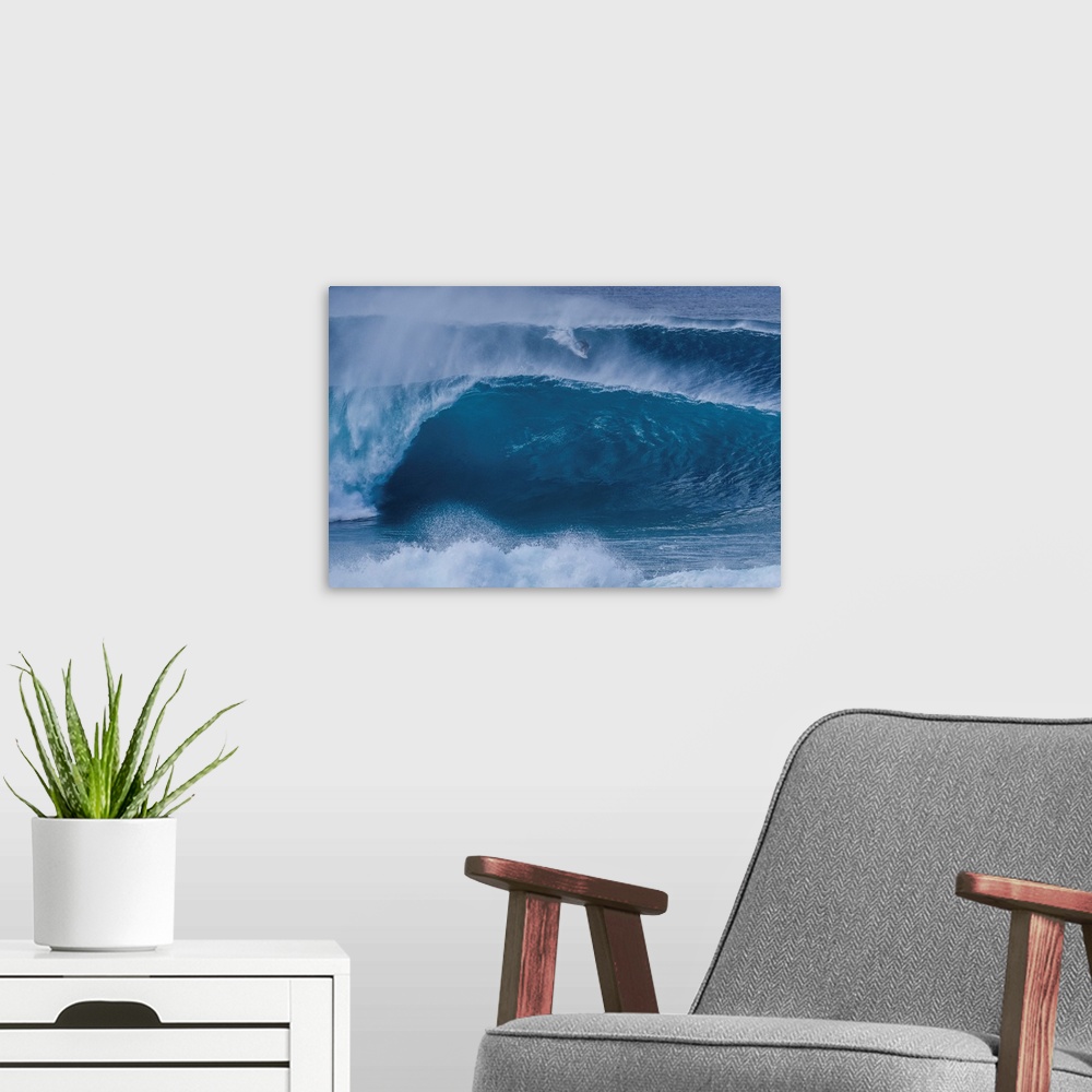 A modern room featuring A surfer rides a wave from the outer reef at the legendary pipeline surf spot on Oahu's north shore.
