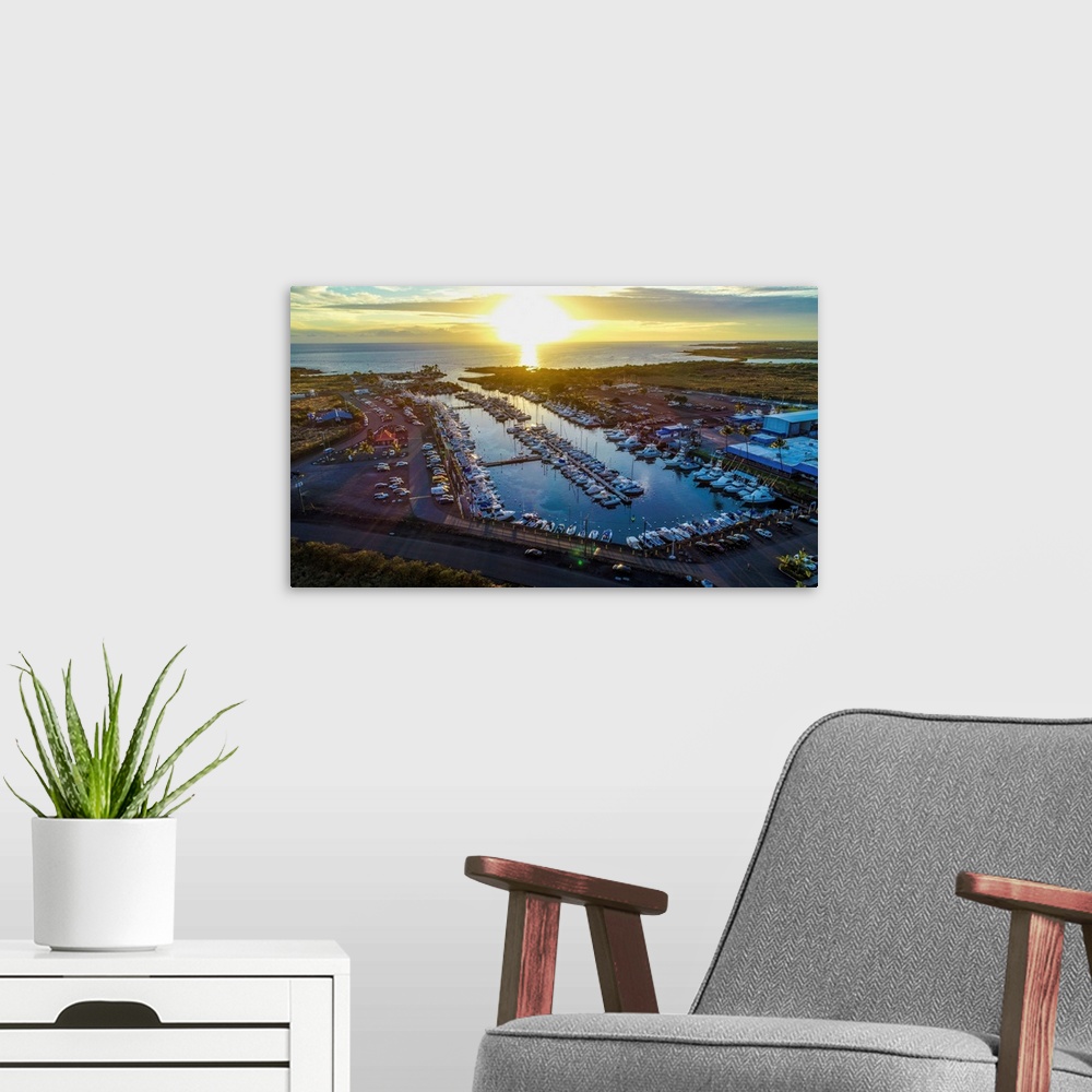 A modern room featuring Aerial photograph of the Kona Marina, Hawaii, at sunset