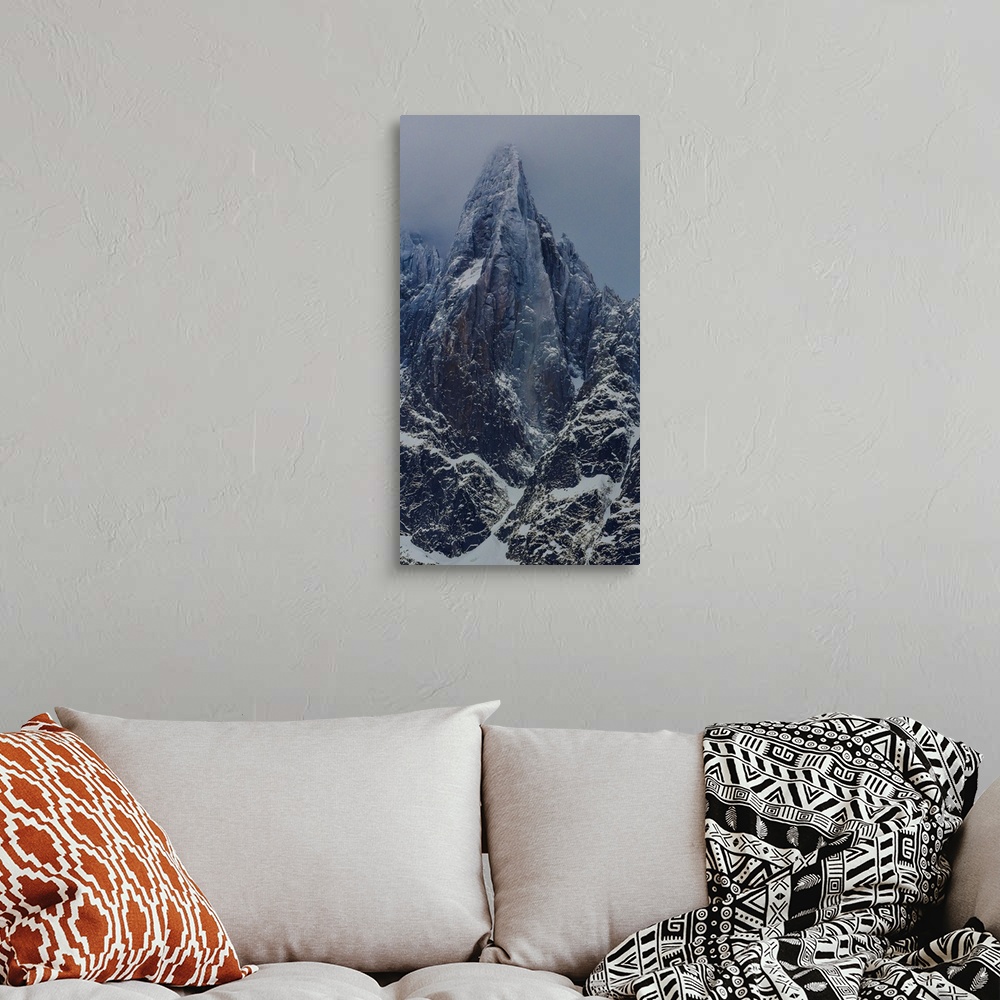 A bohemian room featuring Landscape photograph of the Aiguille du Dru in the Alps with a grey sky.