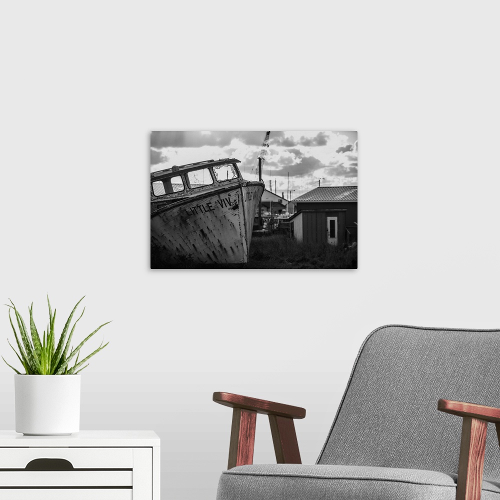 A modern room featuring Black and white image of an old boat in its final resting place PEI Canada
