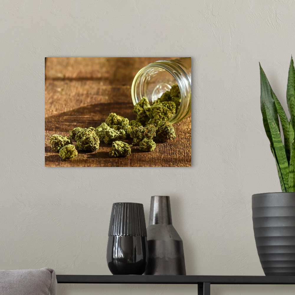 A modern room featuring A glass bowl with harvested cannabis spilling out of it.
