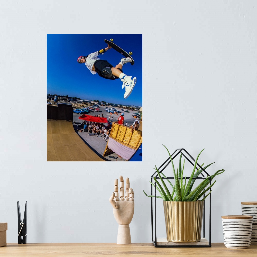 A bohemian room featuring Christian Hosoi skateboarding through the air at Vans Off The Wall Skatepark in Huntington Beach,...