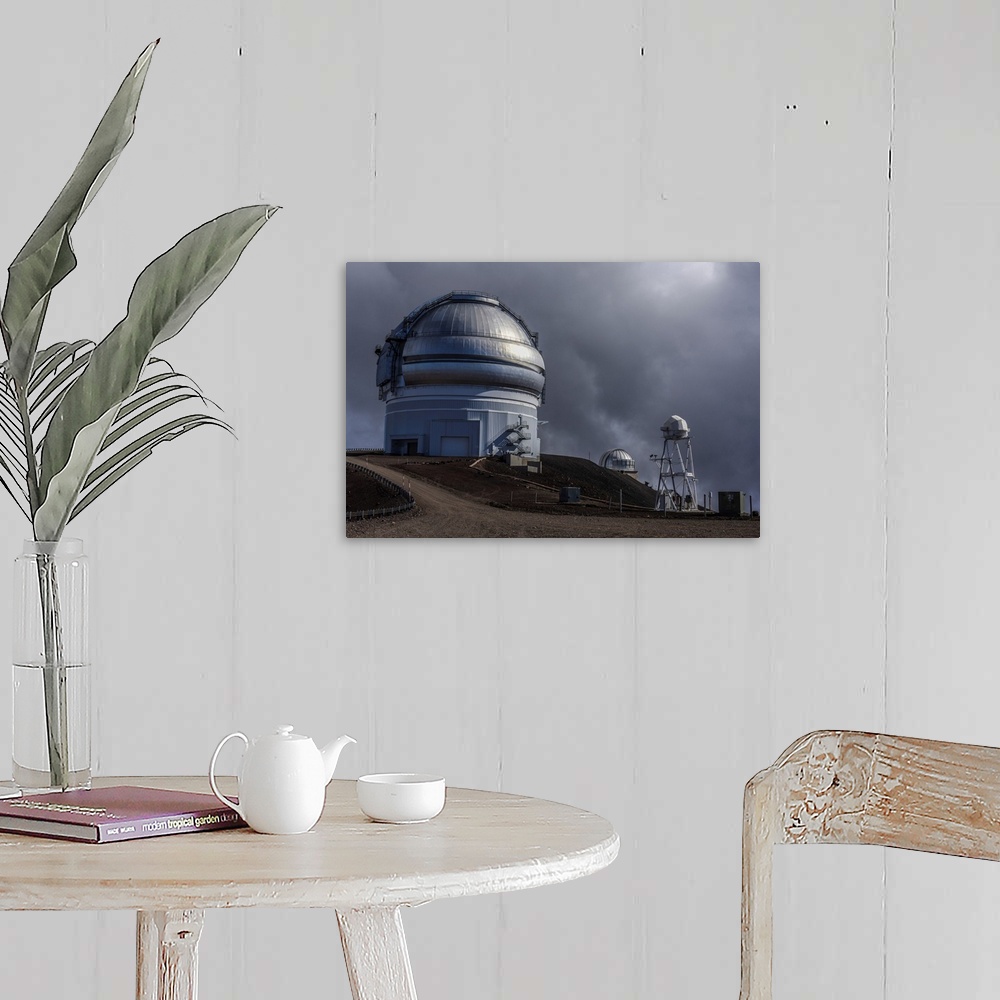 A farmhouse room featuring Big Island Hawaii. Clouds roll in above an observatory on the Mauna Kea volcano in Hawaii.