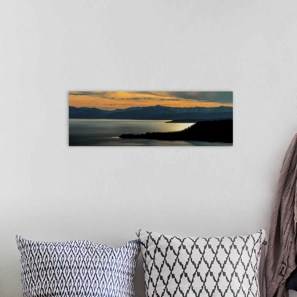 A bohemian room featuring Panoramic view of Lake Tahoe at dusk with sunset light in the sky, California.