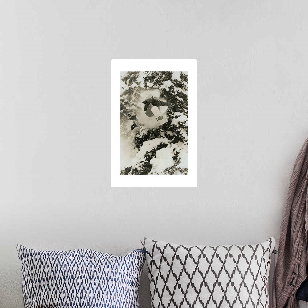 A bohemian room featuring Photograph of Marc Morriset snowboarding over snow covered trees in the Selkirk Mountains, Britis...