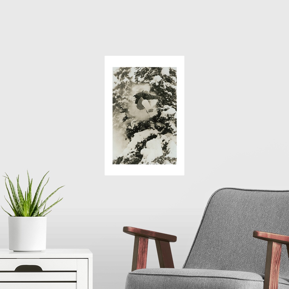 A modern room featuring Photograph of Marc Morriset snowboarding over snow covered trees in the Selkirk Mountains, Britis...