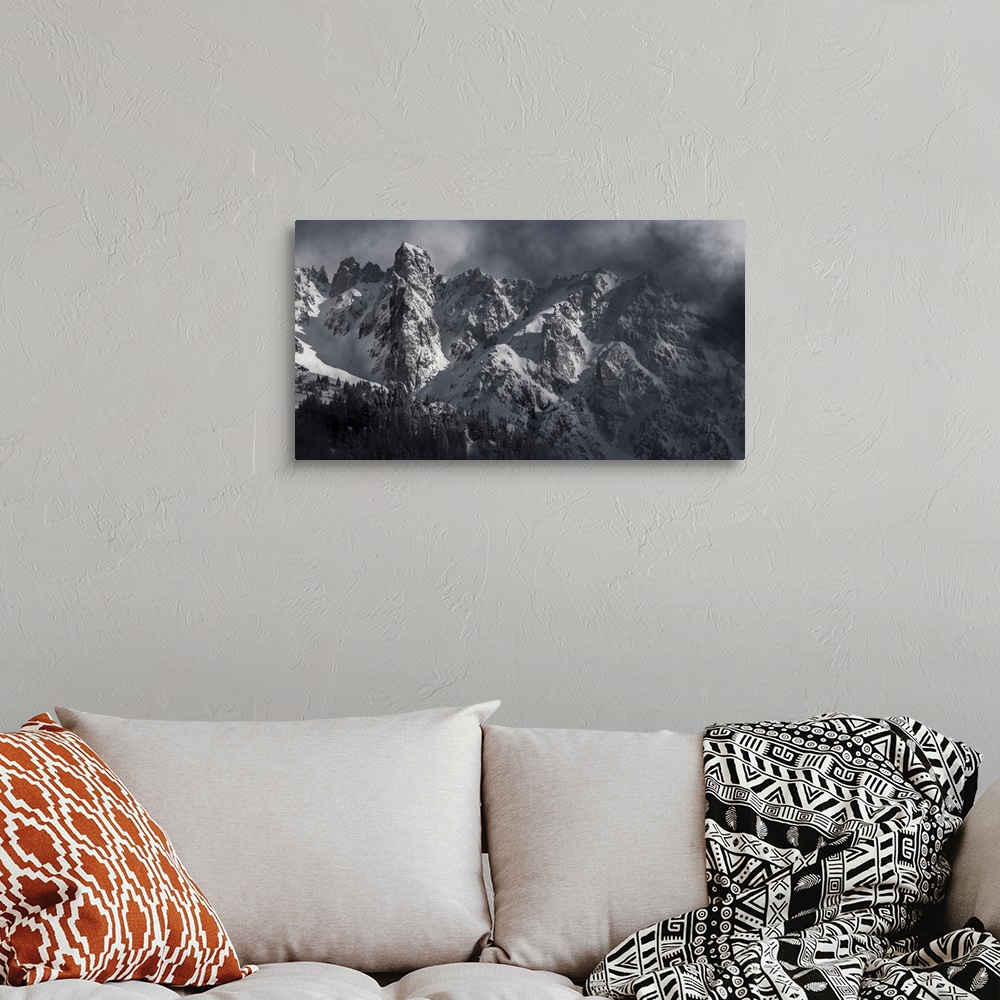 A bohemian room featuring Black and white photograph of a snowy Mont Blanc on a hazy day.