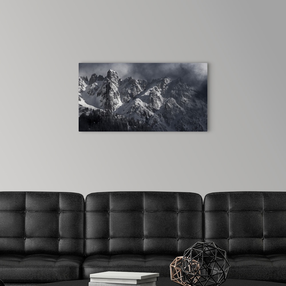 A modern room featuring Black and white photograph of a snowy Mont Blanc on a hazy day.