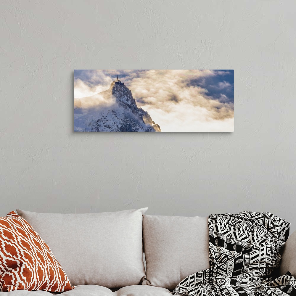 A bohemian room featuring Photograph of Mont Blanc surrounded by sunlit clouds.