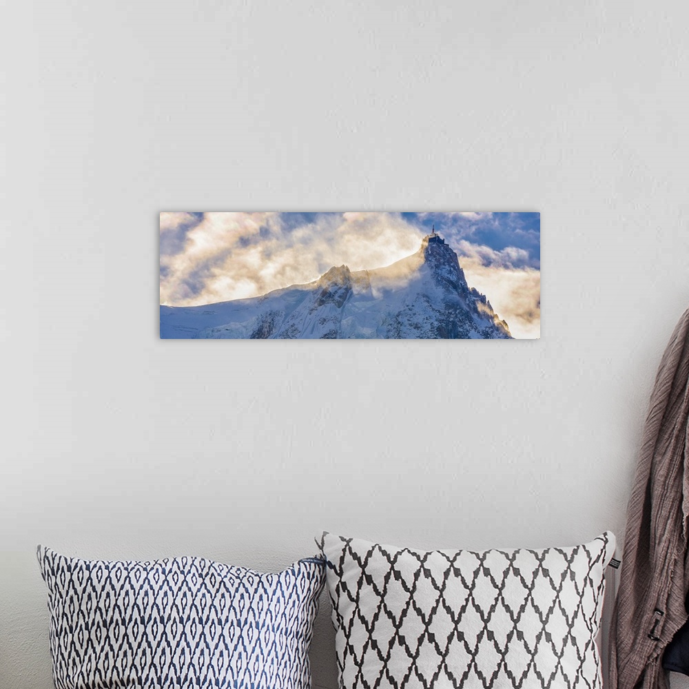 A bohemian room featuring Photograph of Mont Blanc surrounded by sunlit clouds.