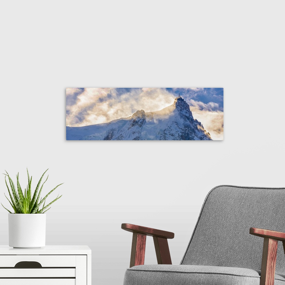 A modern room featuring Photograph of Mont Blanc surrounded by sunlit clouds.