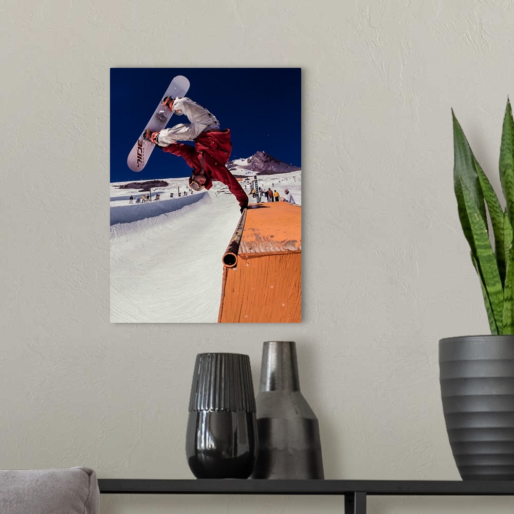 A modern room featuring Pat Abramson performing a snowboarding trick at Mt. Hood, Oregon.