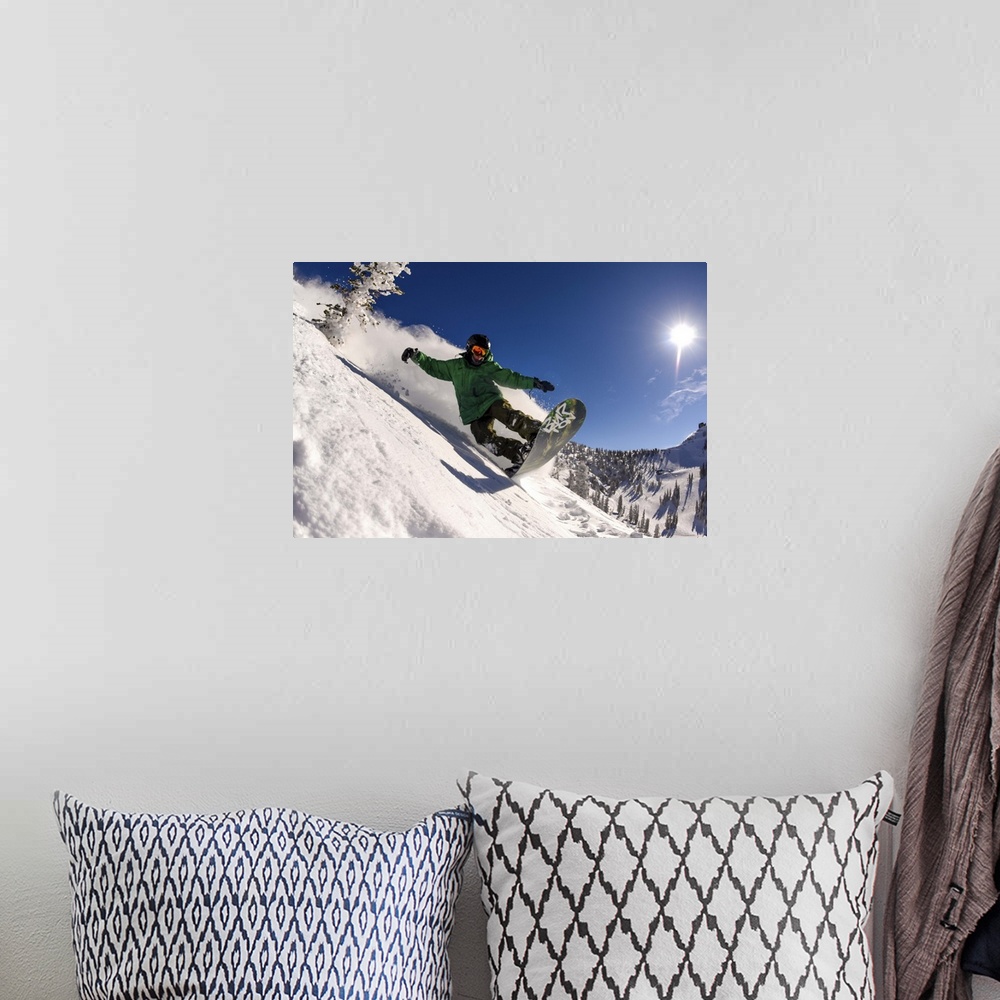 A bohemian room featuring Action shot of a snowboarder riding manual down a slope in Utah.