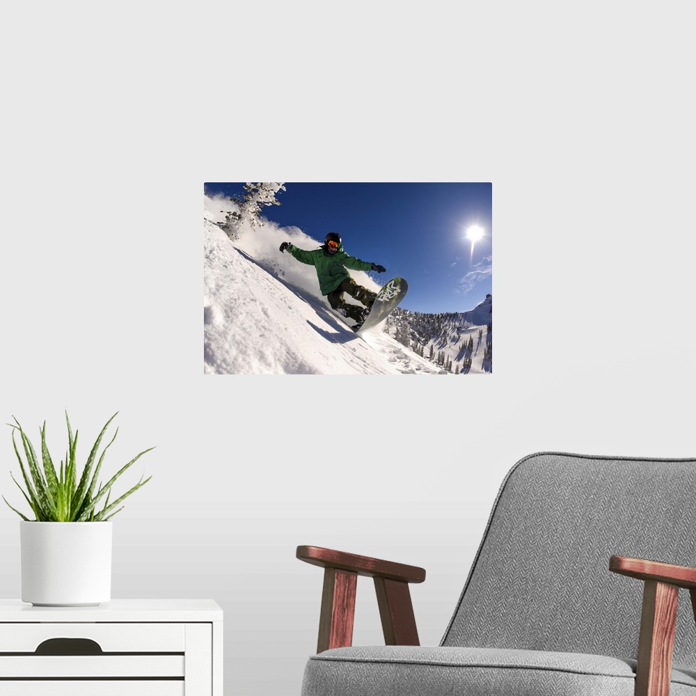 A modern room featuring Action shot of a snowboarder riding manual down a slope in Utah.
