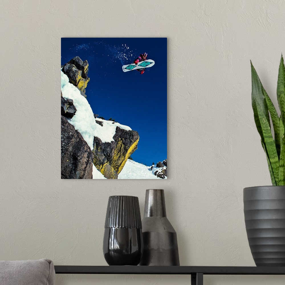 A modern room featuring Shawn Farmer snowboarding through the air at Lake Tahoe, California, 1992.