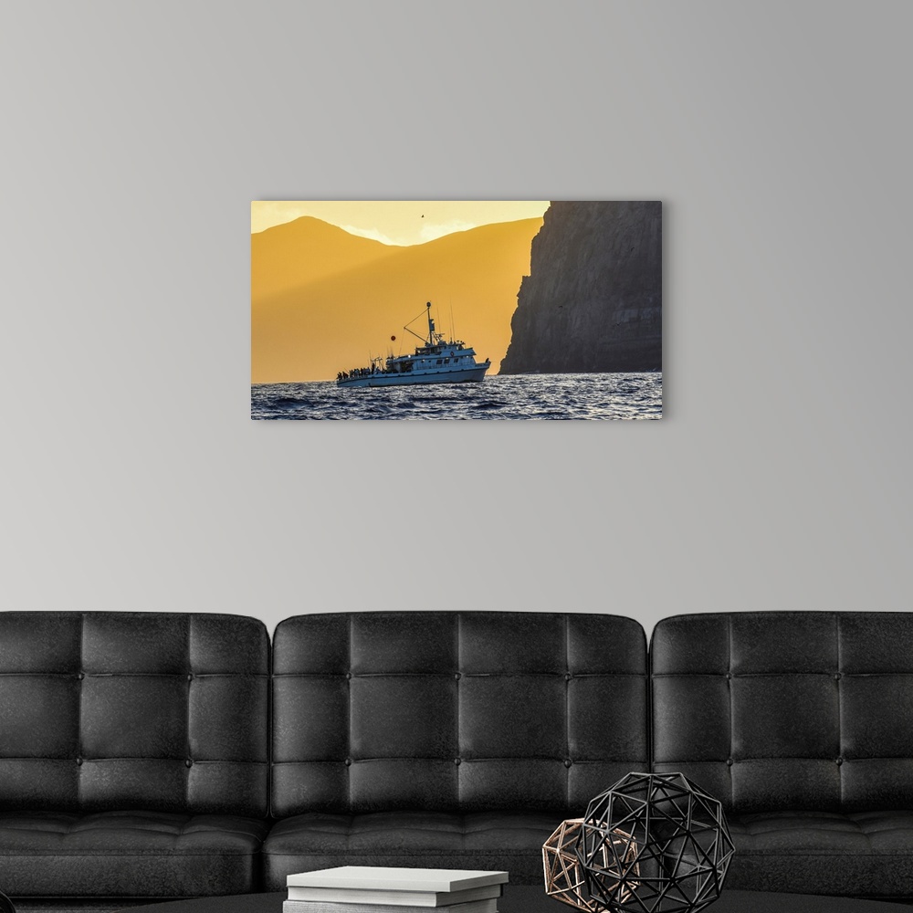 A modern room featuring Guadalupe Island, Mexico. The Royal Polaris fishes in tight at sunset near Guadalupe island, Mexico.