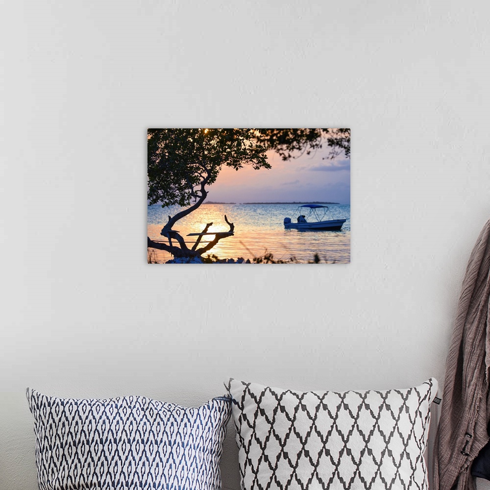 A bohemian room featuring Southern Belize. The sun sets over an insecure fishing perch on Buttonwood Caye in southern Belize.