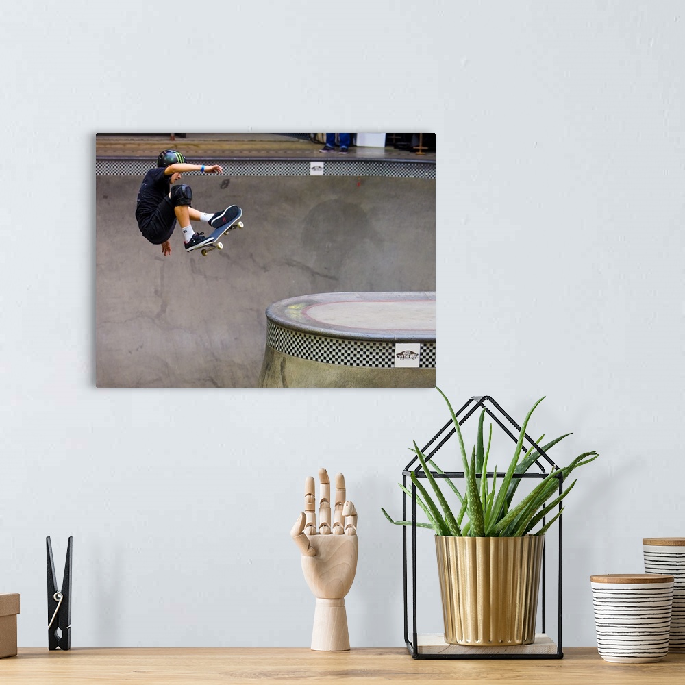 A bohemian room featuring Tom Schaar jumping on his skateboard at Vans Off The Wall Skatepark in Huntington Beach, Californ...